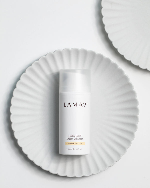 Hydra-Calm Cream Cleanser by LAMAV — 100ml bottle on a white fluted plate | Pure and gentle daily cleanser