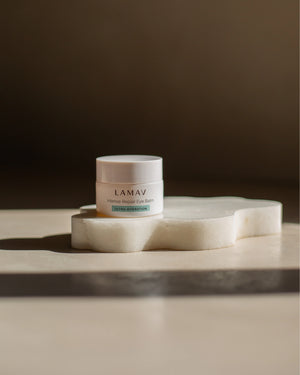 Intense Repair Eye Balm by LAMAV — Closed jar resting on white stone slice | Ultra-hydration for tired eyes