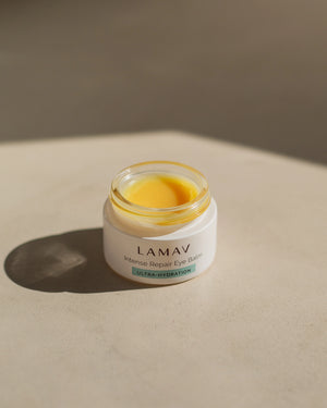 Intense Repair Eye Balm by LAMAV — Open jar on stone showing yellow balm | Rich nourishment for fine lines