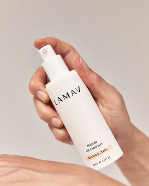 Marula Oil Cleanser by LAMAV — hand holding white pump bottle | deeply cleanses and hydrates