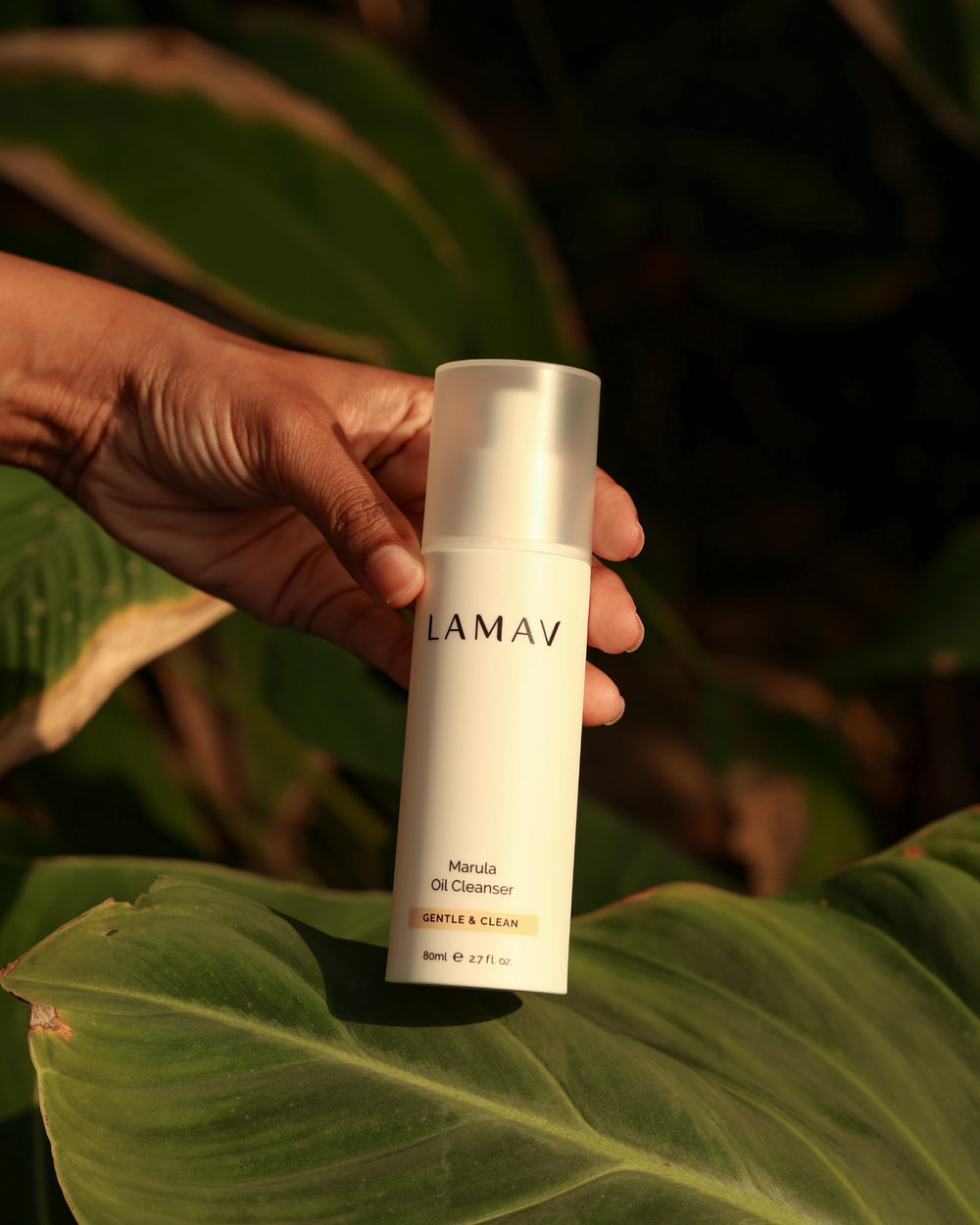 Marula Oil Cleanser by LAMAV — 80ml white airless pump bottle beside Clean + Conscious awards | award-winning organic cleanser