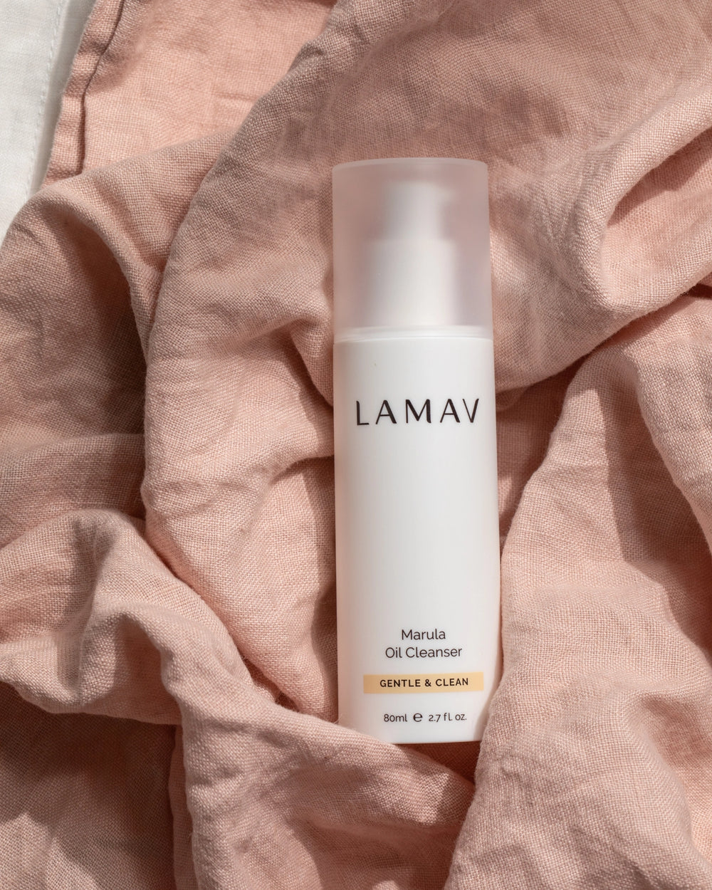 Marula Oil Cleanser by LAMAV — 80ml white airless pump bottle beside Clean + Conscious awards | award-winning organic cleanser