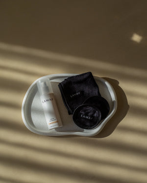 Marula Oil Cleanser by LAMAV — bottle and black cloths in a white tray | gentle organic cleansing