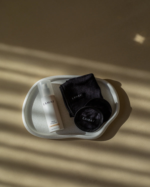 Marula Oil Cleanser by LAMAV — bottle and black cloths in a white tray | gentle organic cleansing