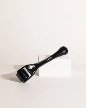 Micro Dermal Roller by LAMAV — resting diagonally on a white rectangular block | improves skin texture