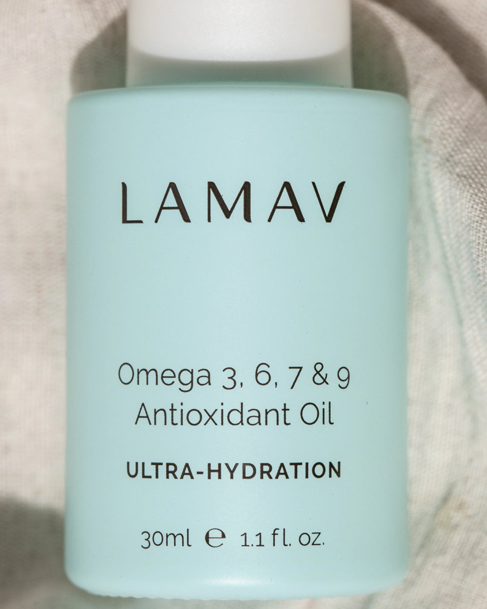 Omega 3, 6, 7 & 9 Antioxidant Oil by LAMAV — light blue dropper bottle beside 2021 beauty awards | ultra-hydration face oil
