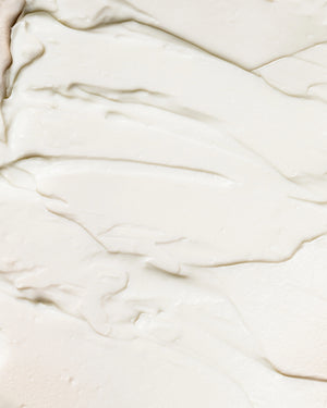 Organic Bio-Active Primer by LAMAV — bottle on a cream texture swatch | smooth base for makeup