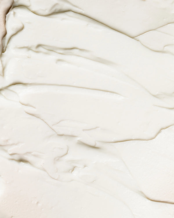 Organic Bio-Active Primer by LAMAV — bottle on a cream texture swatch | smooth base for makeup