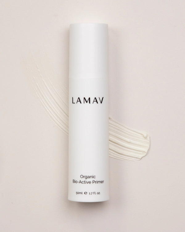 Organic Bio-Active Primer by LAMAV — bottle on a cream texture swatch | smooth base for makeup