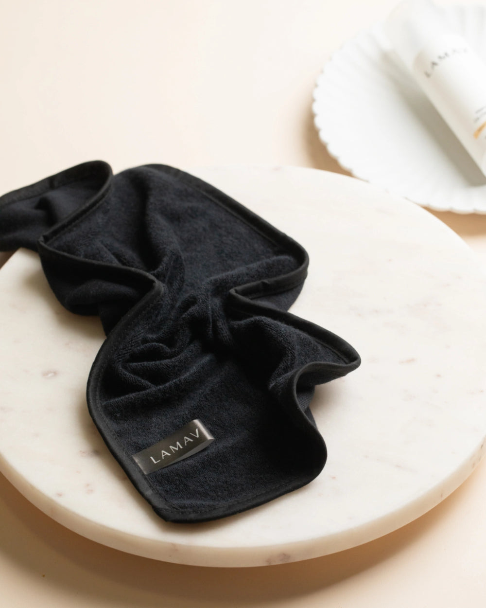 Reusable Bamboo Cleansing Facial Cloth & Makeup Wipes by LAMAV — two round pads and one folded cloth isolated on white | eco-friendly makeup removal