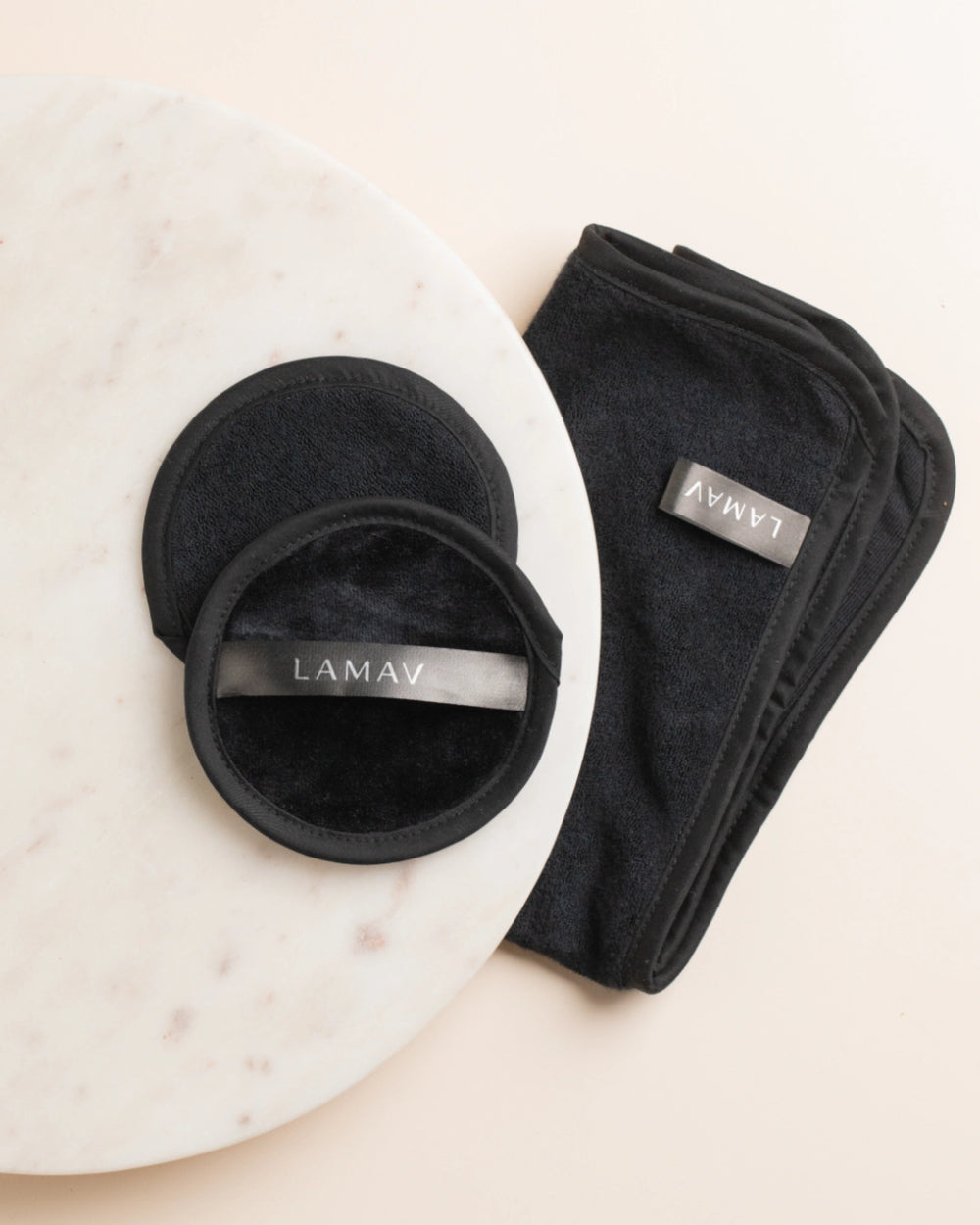 Reusable Bamboo Cleansing Facial Cloth & Makeup Wipes by LAMAV — two round pads and one folded cloth isolated on white | eco-friendly makeup removal
