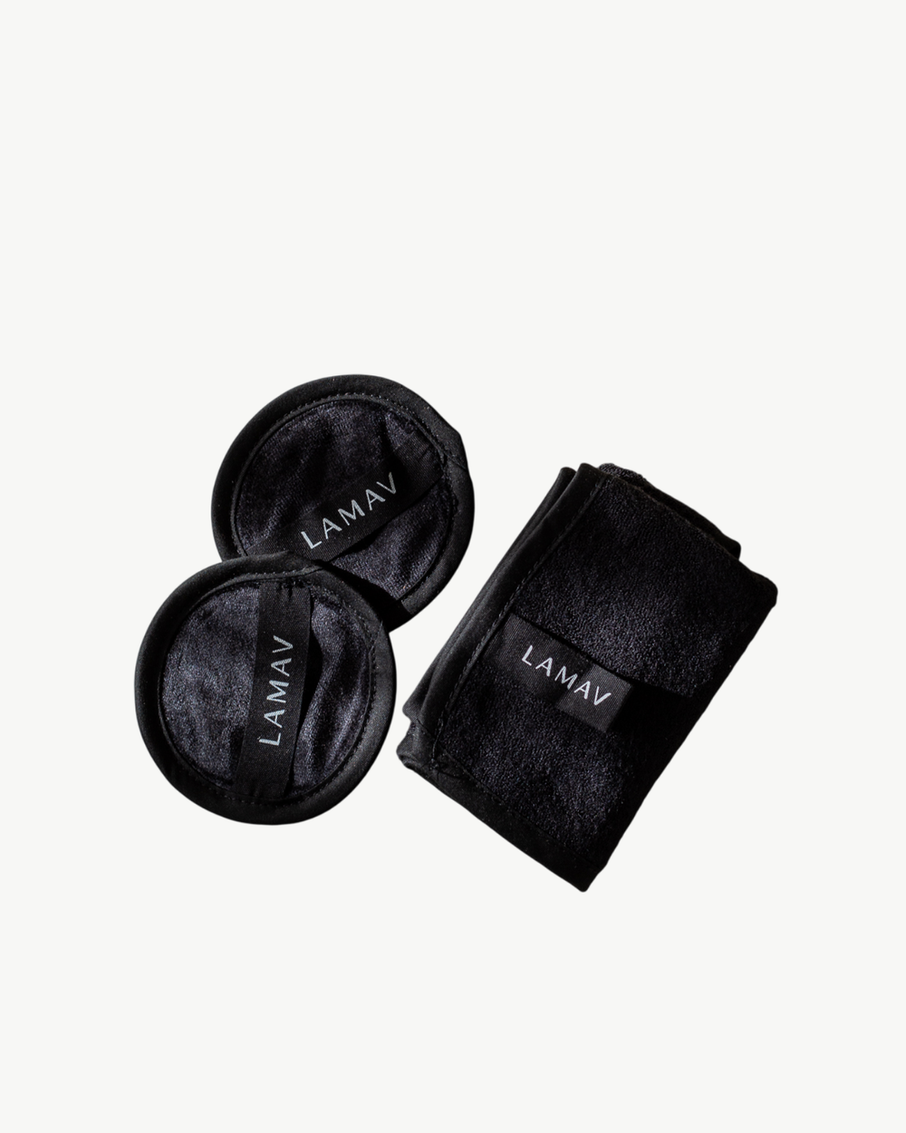 Reusable Bamboo Cleansing Facial Cloth & Makeup Wipes by LAMAV — two round pads and one folded cloth isolated on white | eco-friendly makeup removal