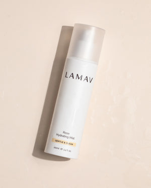 Rose Hydrating Mist by LAMAV — bottle lying flat on a wet surface | dewy moisture boost