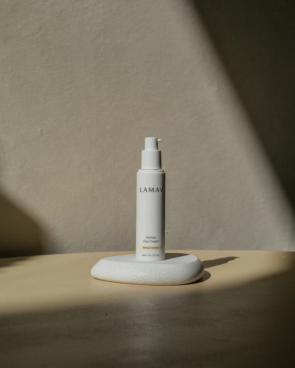 Rumex Advanced Lightening Cream by LAMAV — bottle on white stone with shadow | brightens dull skin