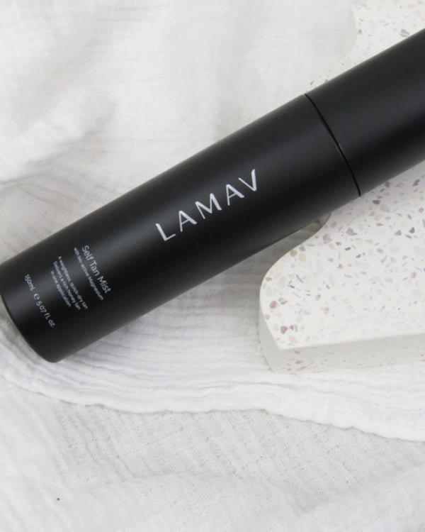 Self Tan Mist by LAMAV — black bottle on a terrazzo stone and linen | hydrating self tan