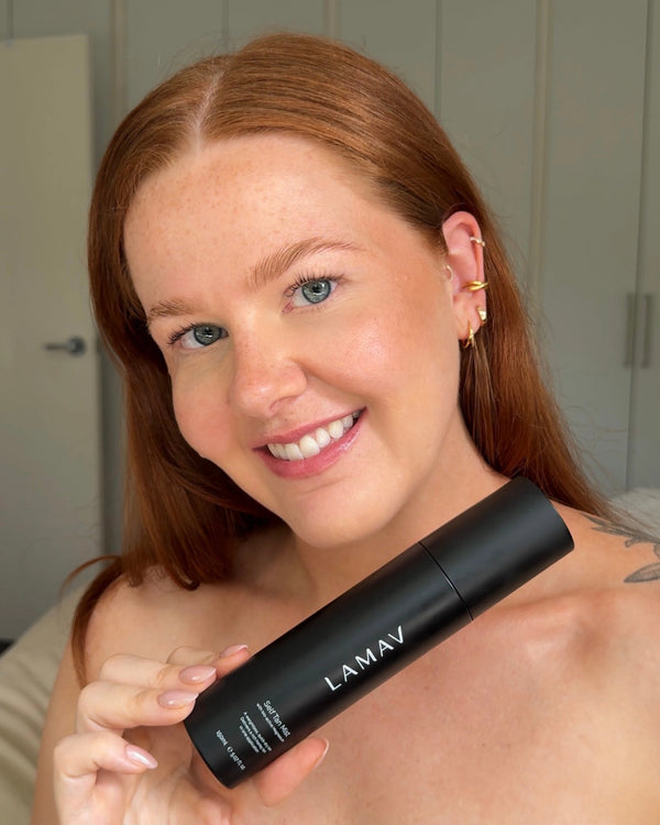 Self Tan Mist by LAMAV — smiling woman holding black spray bottle | flawless natural tan