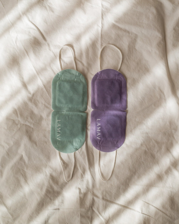 Self-Warming Eye Mask by LAMAV — green and purple masks flat on sheet | dual scent options