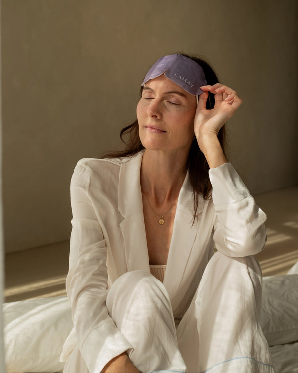 Self-Warming Eye Mask by LAMAV — woman relaxing in bed wearing purple mask | deeper rest