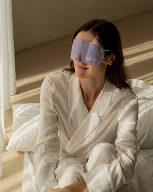Self-Warming Eye Mask by LAMAV — smiling woman in bed wearing purple mask | soothing comfort