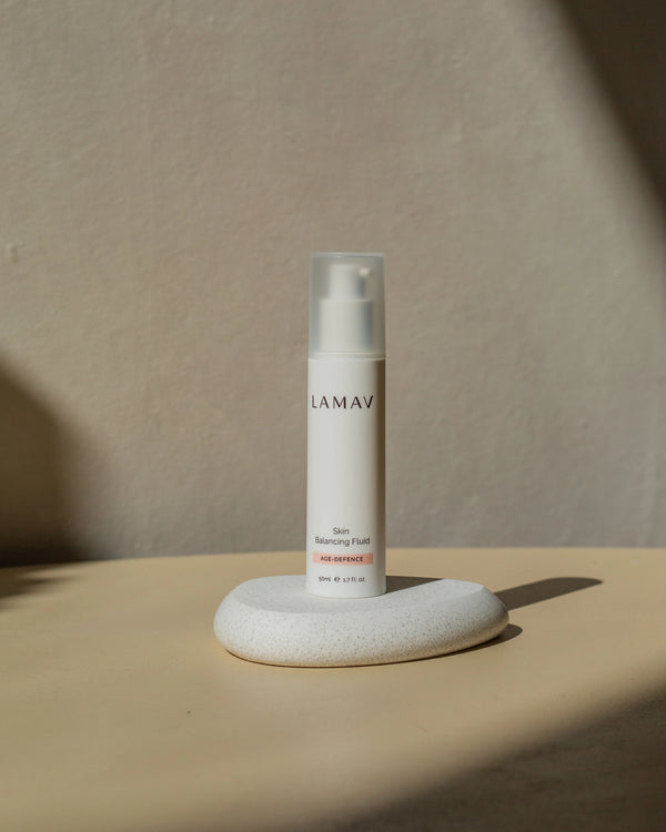Skin Balancing Fluid by LAMAV — bottle resting on white stone | natural age-defying daily lotion