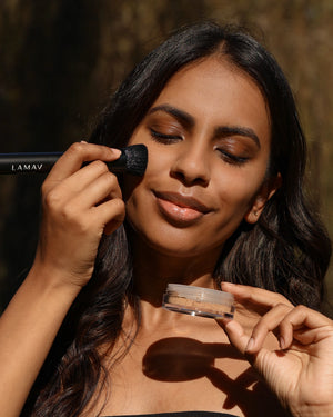 Sunkissed Bronzer by LAMAV — smiling woman applying powder outdoors | effortless radiant summer glow