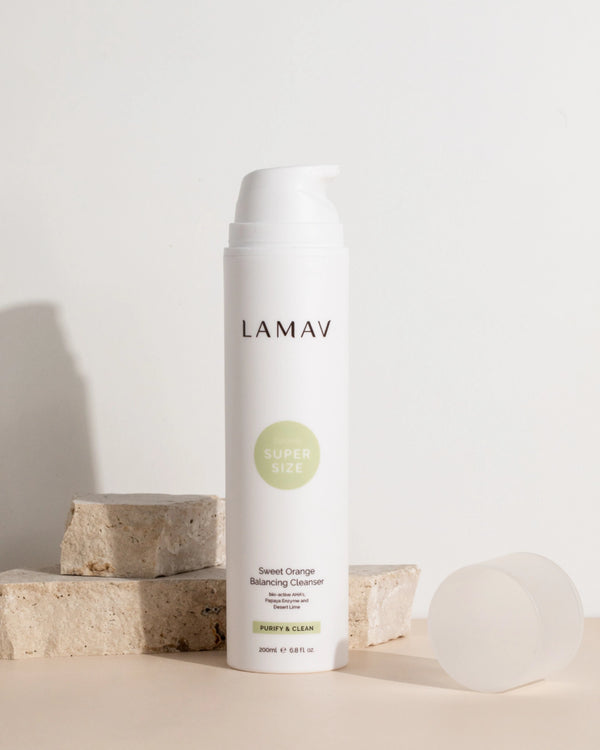 Super Sized Sweet Orange Balancing Cleanser by LAMAV — bottle with cap off on stone blocks | gently balances oily skin