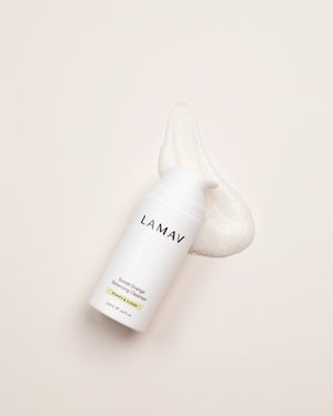 Sweet Orange Balancing Cleanser by LAMAV — bottle next to a smear of foaming cleanser | deeply cleans pores
