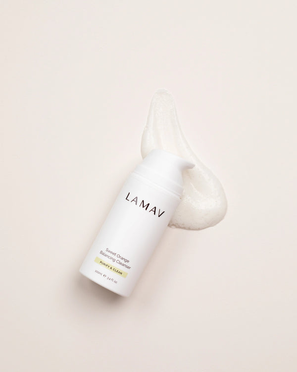 Sweet Orange Balancing Cleanser by LAMAV — bottle next to a smear of foaming cleanser | deeply cleans pores