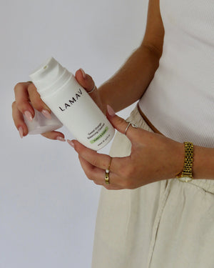 Sweet Orange Balancing Cleanser by LAMAV — woman holding bottle and removing cap | ready for daily cleanse