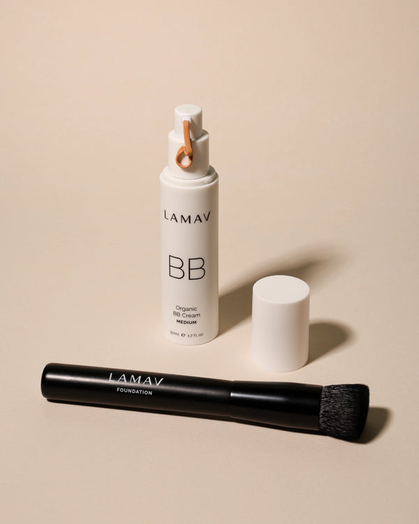 Vegan Foundation Brush by LAMAV — laying next to open BB Cream pump | soft bristles for liquid or powder
