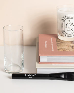 Vegan Mask Brush by LAMAV — black brush resting flat on a white table | seamless skincare blending