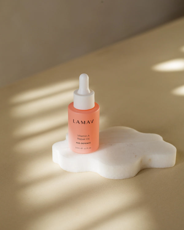 Vitamin A Repair Oil by LAMAV — bottle resting on a white marble stone | luxurious anti-aging treatment