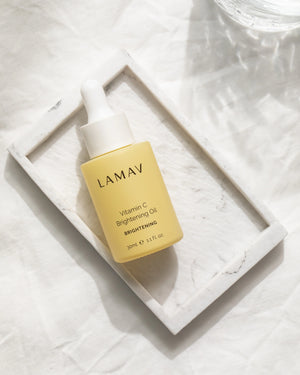 Vitamin C Brightening Oil by LAMAV — bottle resting inside a white marble tray | luxurious organic skincare