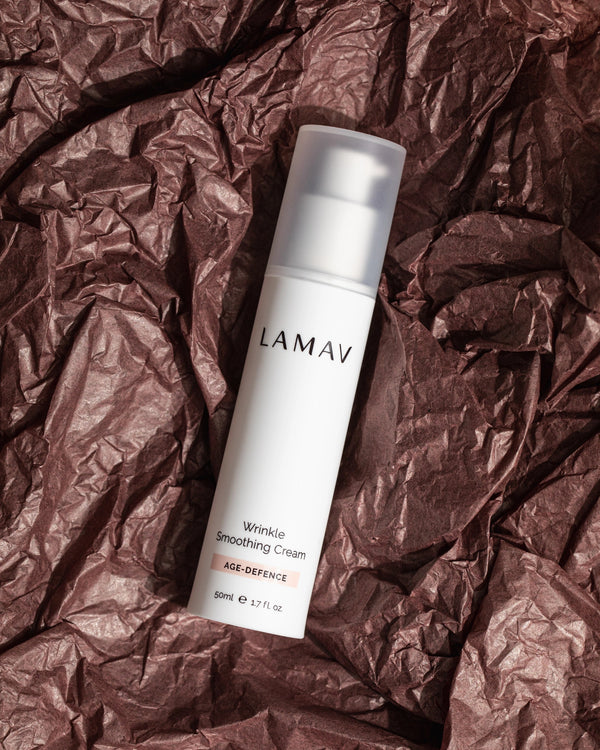 Wrinkle Smoothing Cream by LAMAV — bottle displayed on crumpled brown paper background | deeply hydrates dry skin