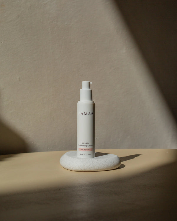 Wrinkle Smoothing Cream by LAMAV — pump bottle resting on a small white stone | firms and smooths mature skin